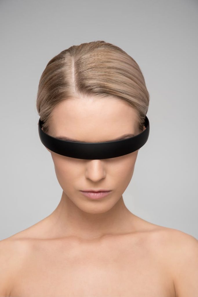 topless-woman-wearing-black-headband-1036642 A captivating portrait of a woman with a sleek VR headset, depicting a futuristic theme.